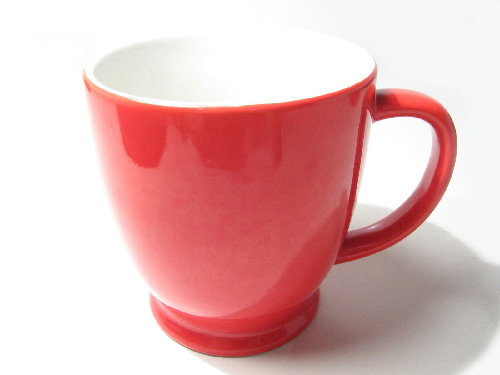 A coffee lovers red and white coffee cup